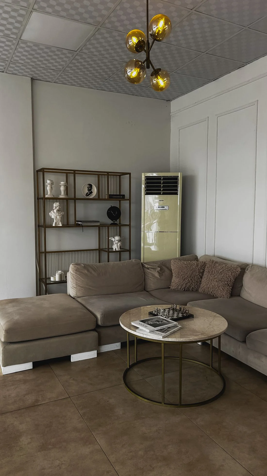 Round coffee table in front of a brown sectional sofa