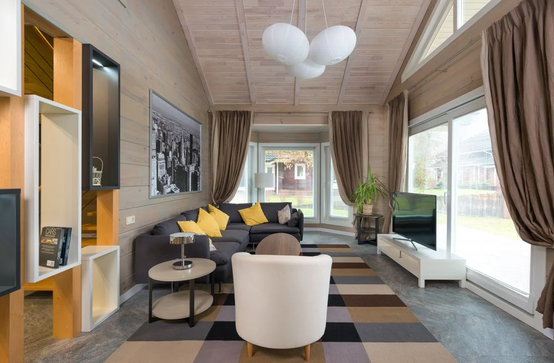 Living room with full-length curtains and broad windows