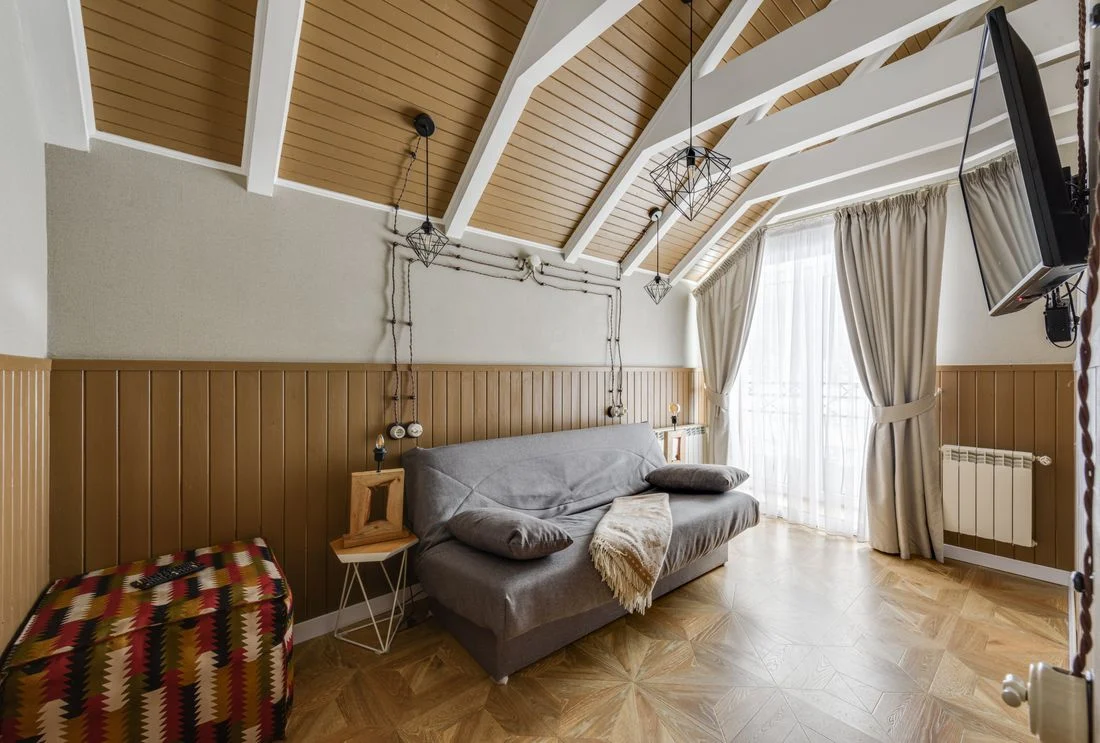 Small sitting room with a sofa bed beneath a pitched ceiling
