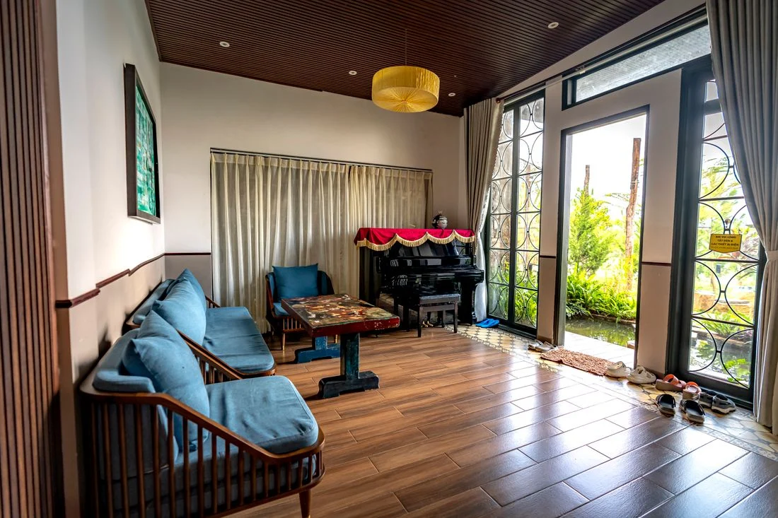 Living room seating with a piano at the far end