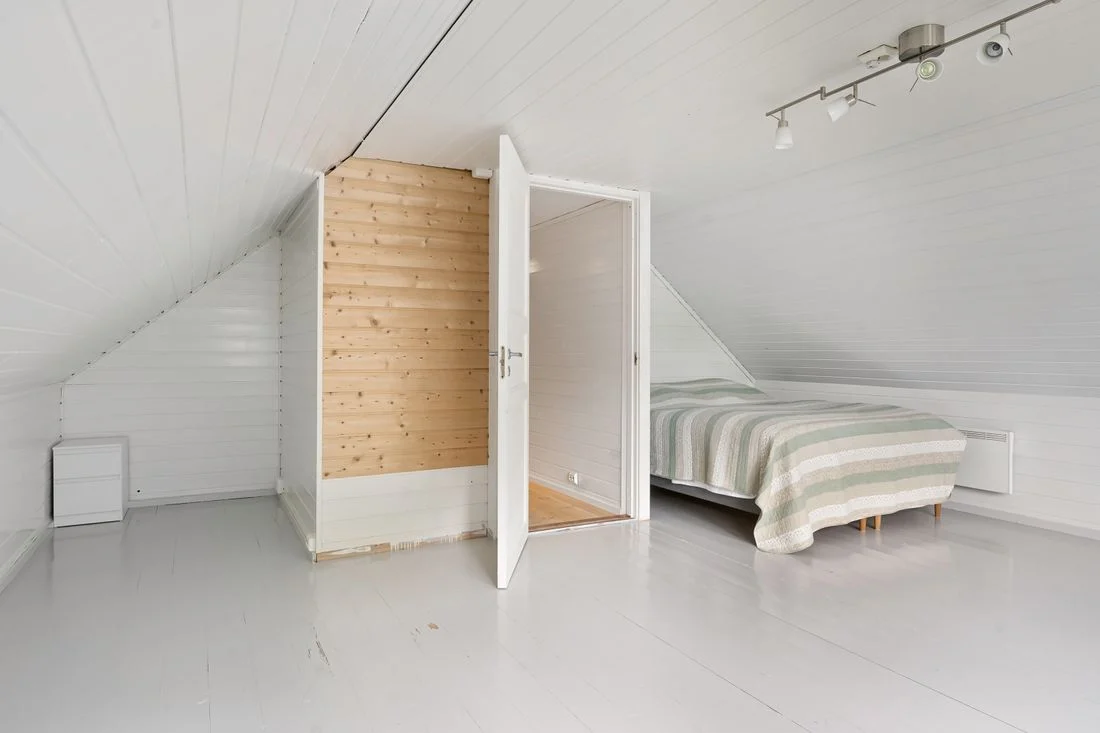 Minimal attic bedroom with a low sloping ceiling