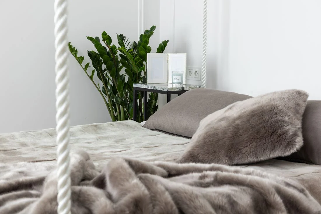 Close view of a bed with textured blanket and pillows