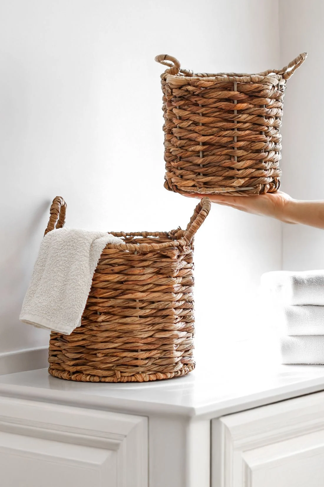 White towels and woven bathroom baskets