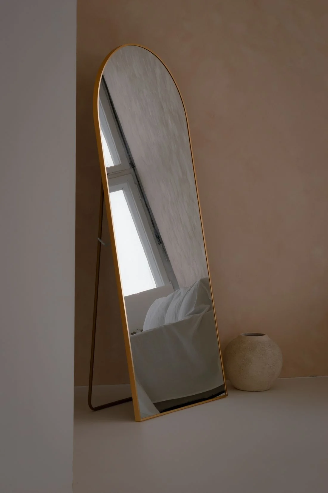 Standing mirror in a softly lit interior