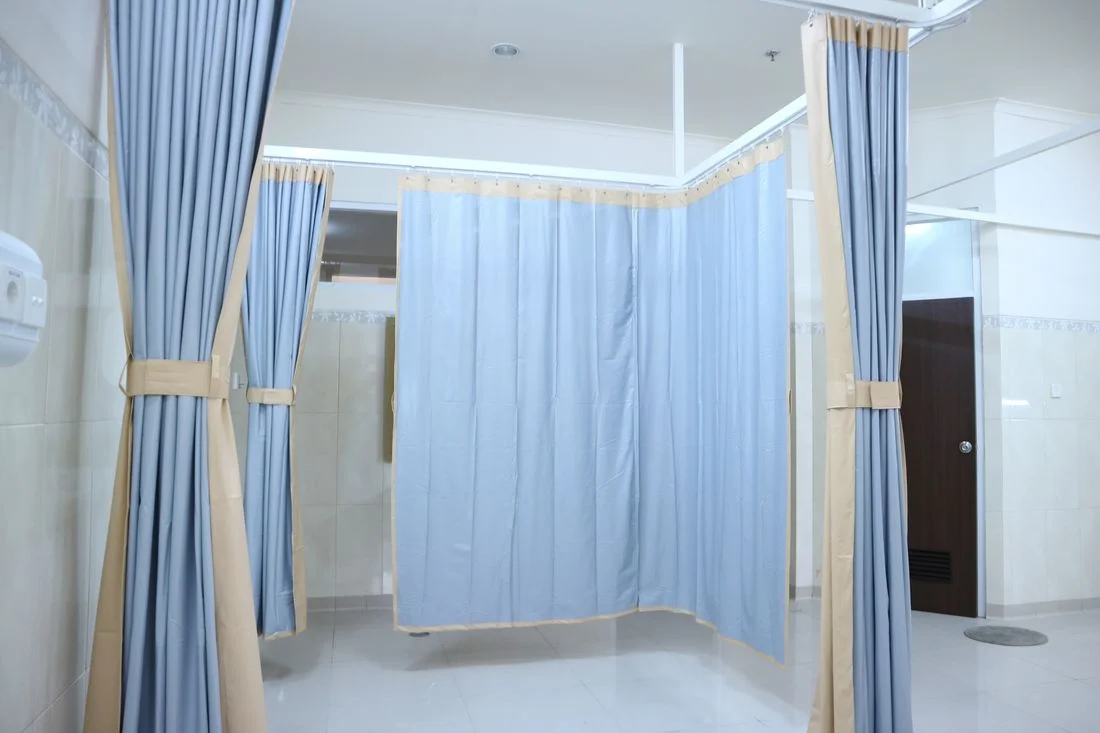 Blue curtains framing a bright window