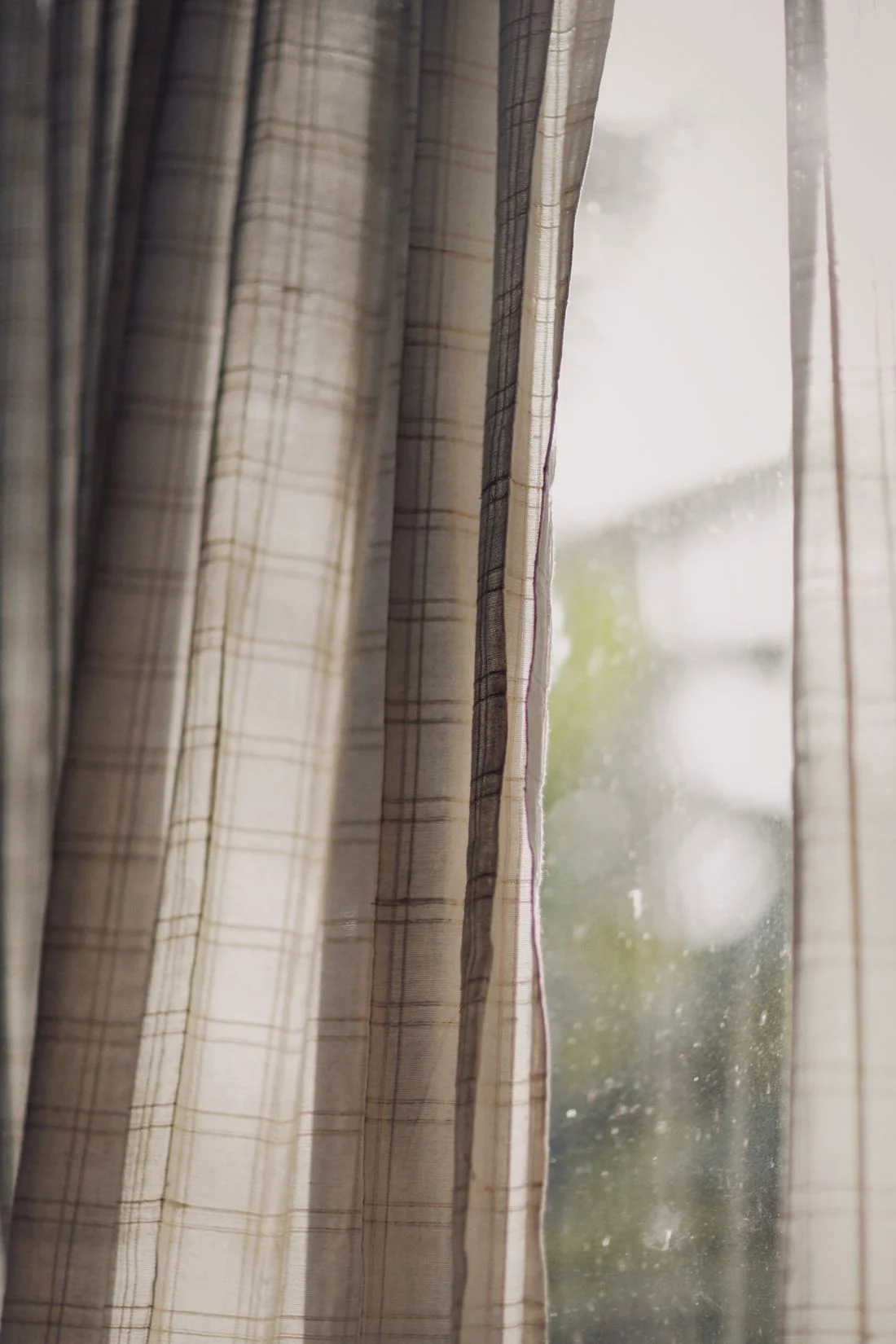 Checkered curtains filtering daylight