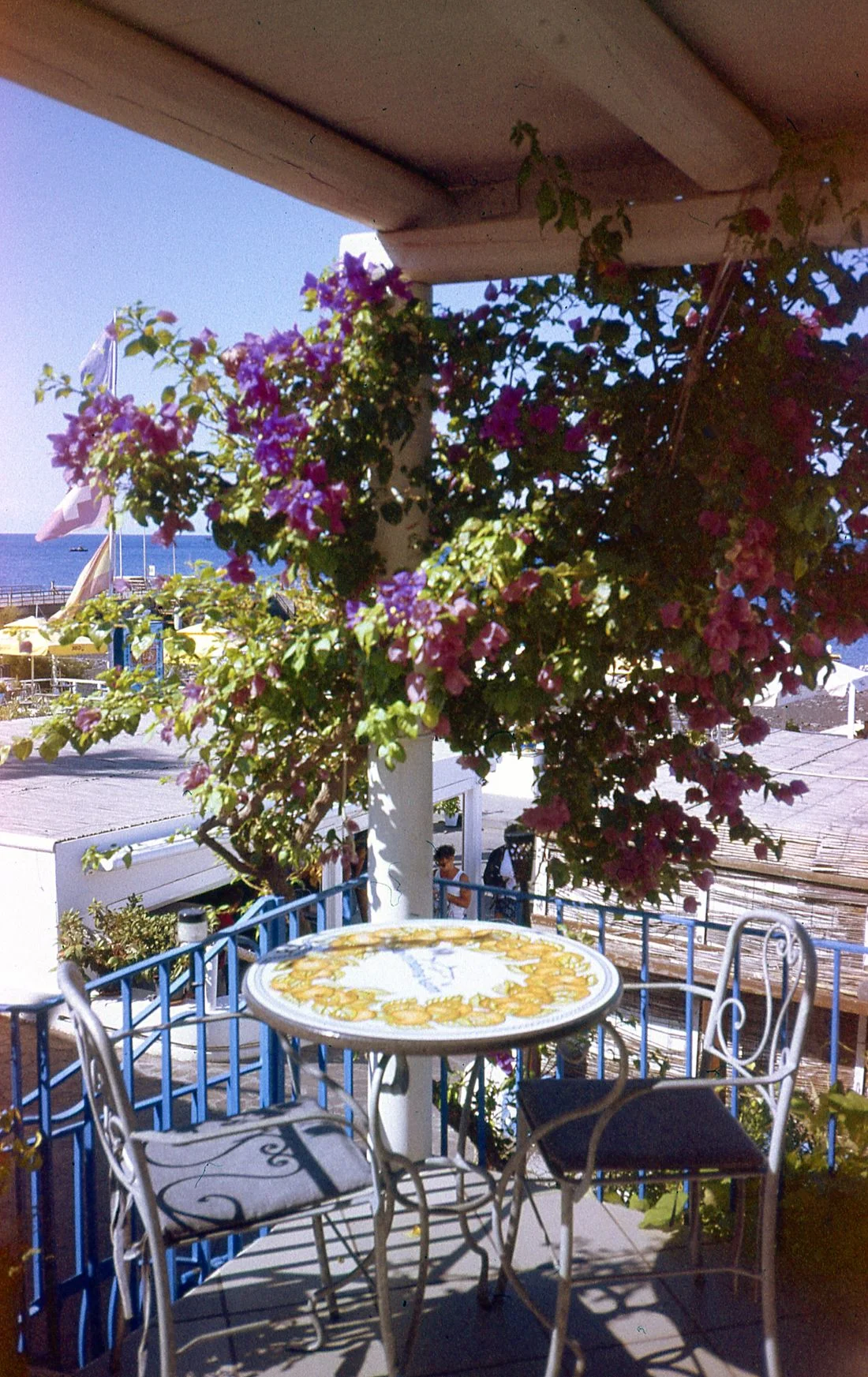 Small balcony with table, two chairs and flowers