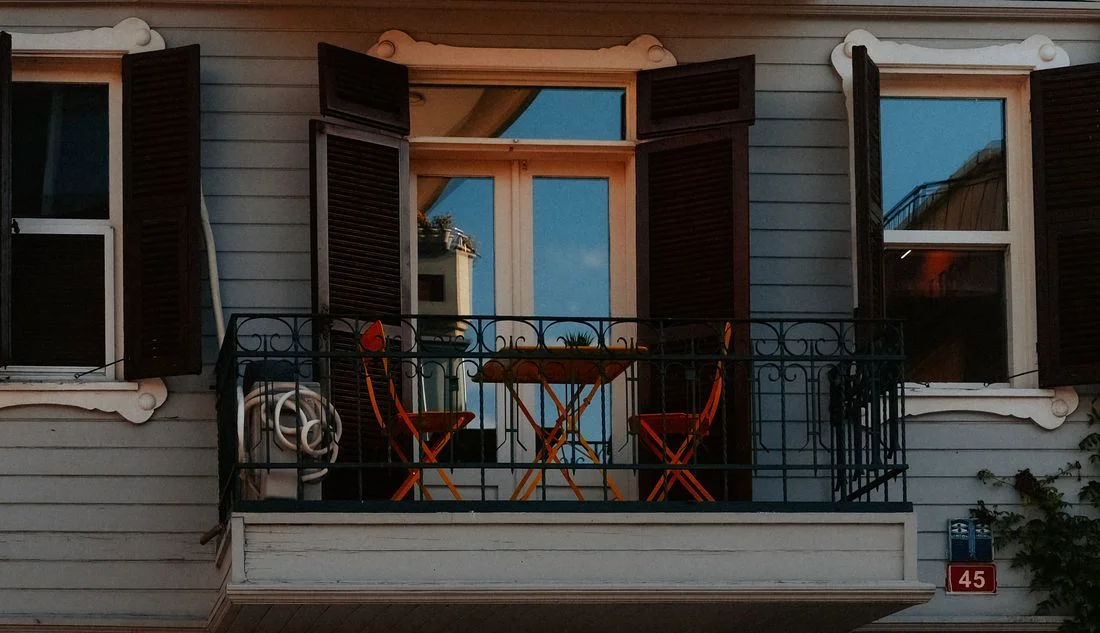 Orange chairs on a small balcony